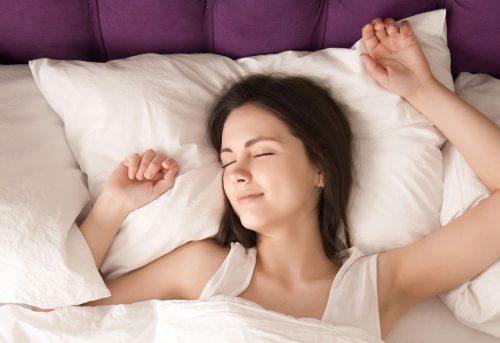 relaxed-woman-lying-with-eyes-closed-bed